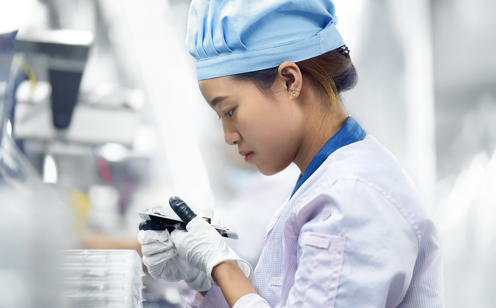 A line operator assembles an iPhone in Shanghai