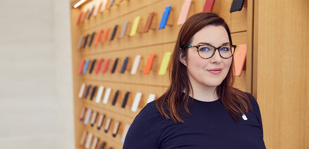 Melissa, an Apple Store Genius, stands in the accessories section of the store.