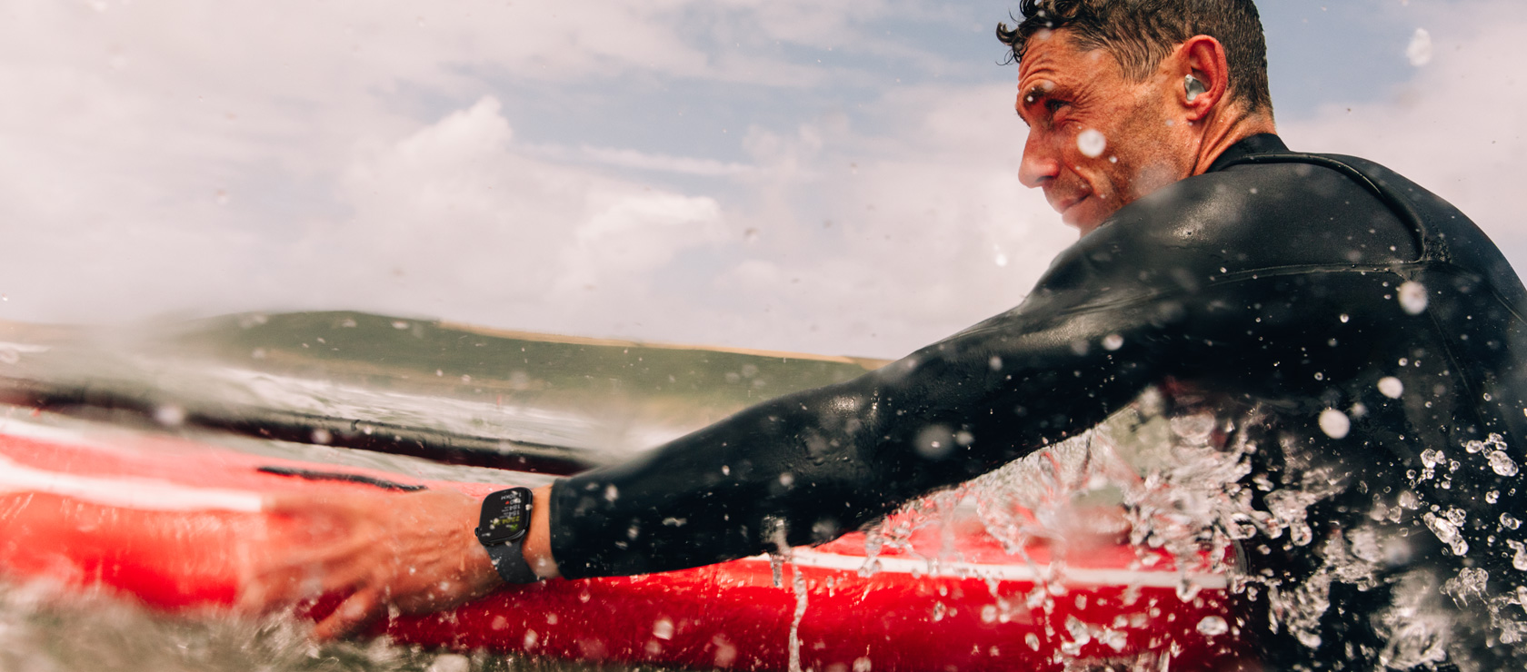 A man with a paddle board in the water wearing Apple?Watch Series?10.