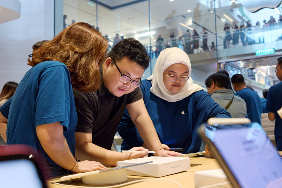 Các nhan viên Apple The Exchange TRX cùng m?t khách hàng ?ang s? d?ng Apple Pencil và iPad. 