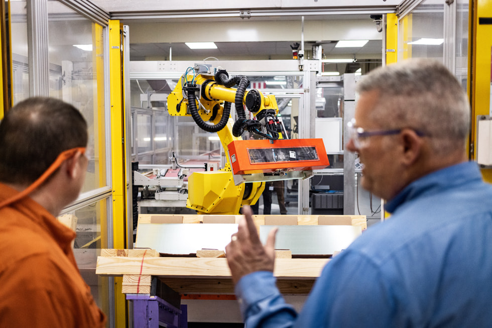 Two workers look through a window inside Corning’s Harrodsburg, Kentucky, facility.