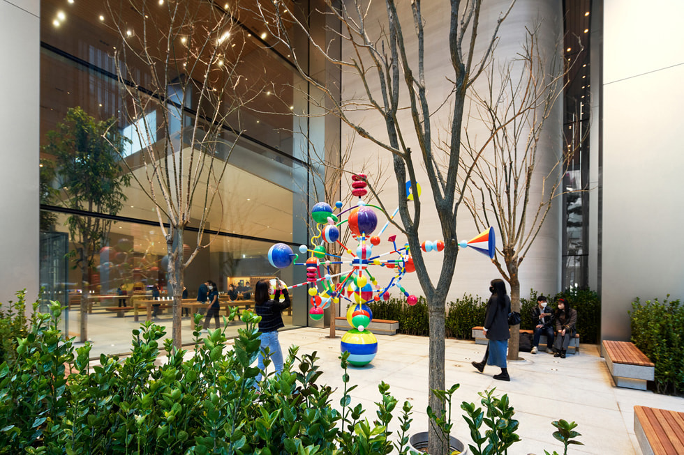 Customers explore a pocket garden outside of Apple Myeongdong.