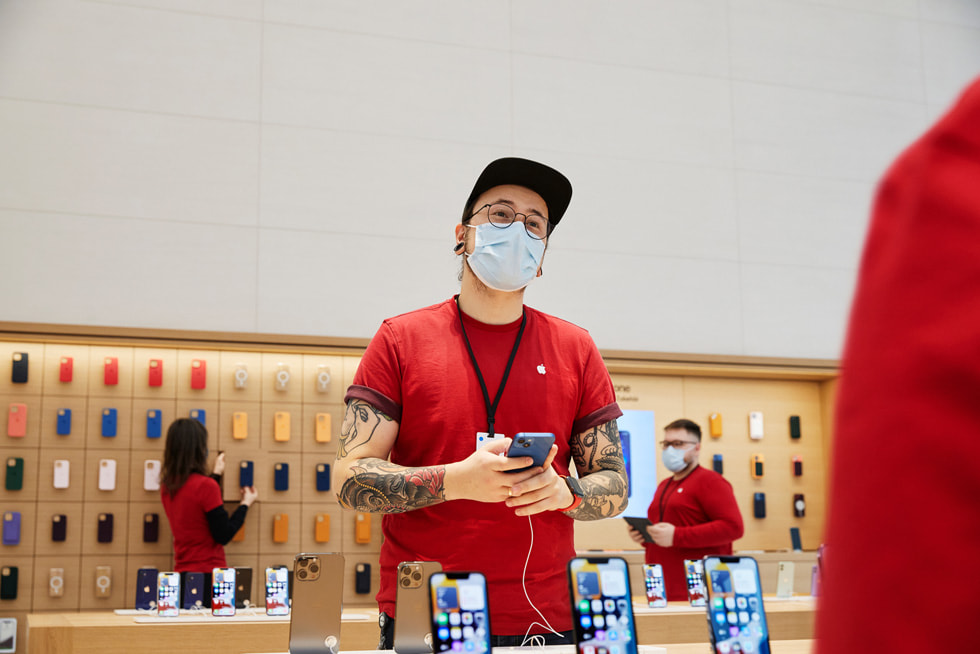 Apple Rosenthaler Stra?e team member setting up iPhone display tables.