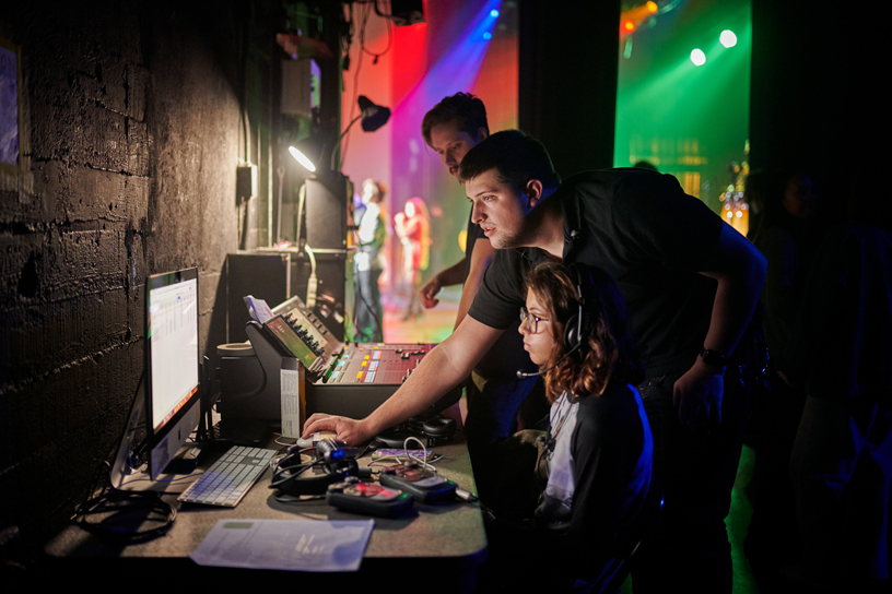 Josh Behrens assists the student crew backstage.