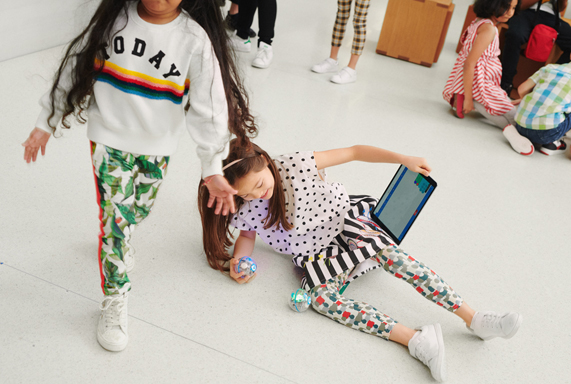 Two kids using an iPad at an Apple Store in Europe.
