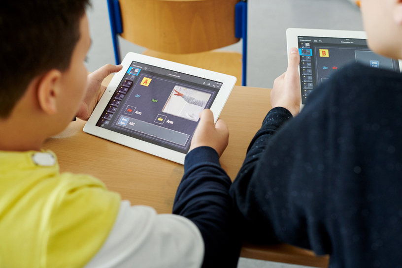 Two students using iPad.