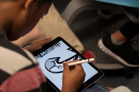 Student drawing on iPad with Apple Pencil.