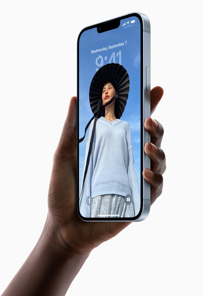 A hand holds up the new iPhone 14 Plus.