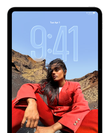 iPad showing Lock Screen where large numerals for the time appears behind the picture of a person sitting